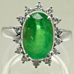 Ring containing a Colombian Emerald surrounded with diamonds